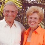 Jack and Joann Goldstein standing in arm with each other and smiling.