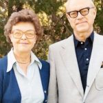 Barbara and Robert “Bob” Wilson standing together and clasping hands.