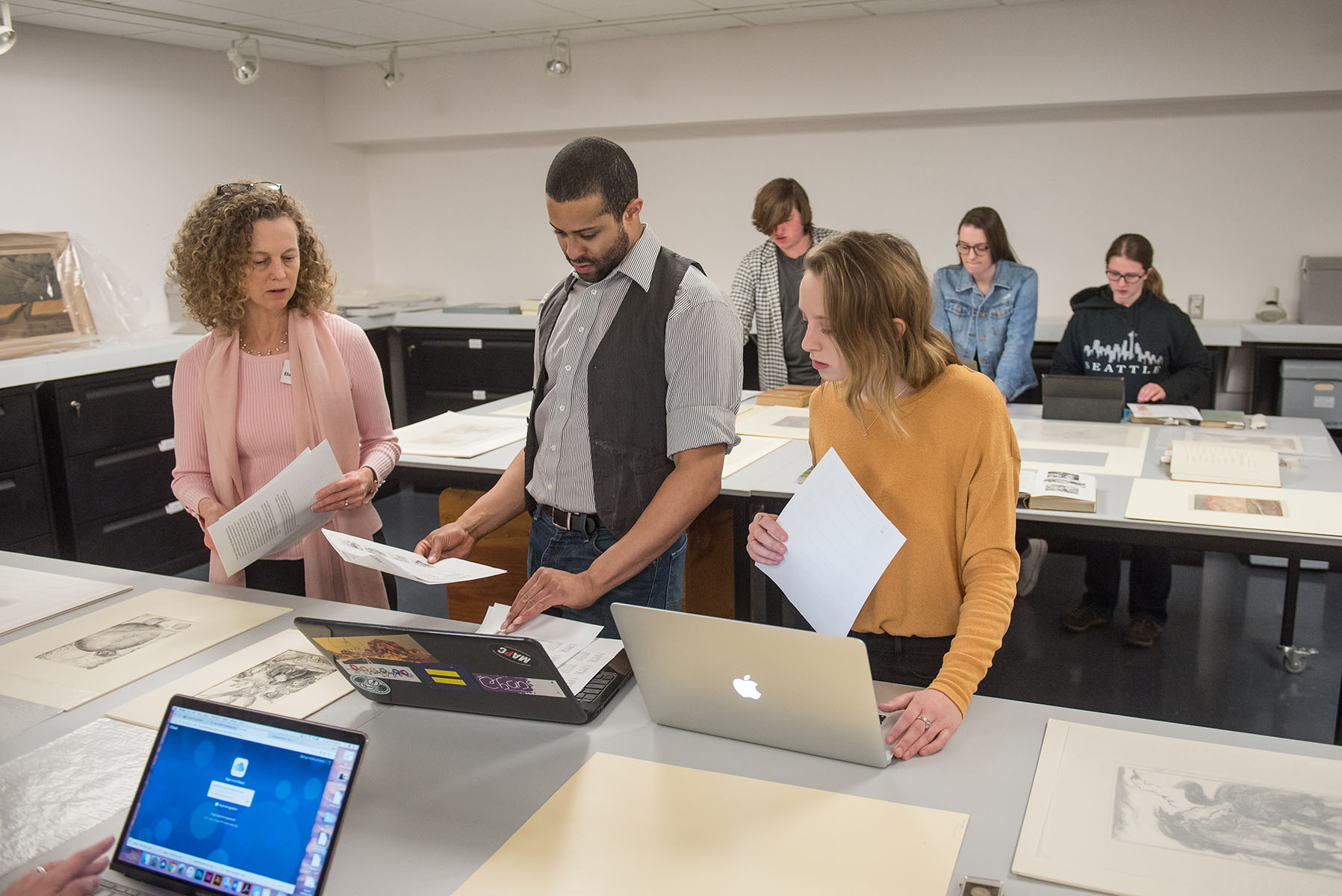 Students evaluating works on paper with Elizabeth Seaton, museum curator.