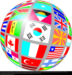 Picture of a globe with flags from different countries all around it.