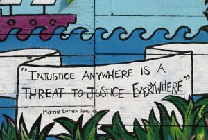 Quote by Martin Luther King Jr.: "Injustice anywhere is a threat to justice everywhere."