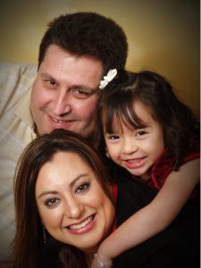 Picture of the author with her husband and daughter.