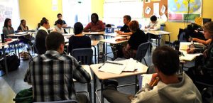 Picture of high school students in a Socratic circle. Half the students are sitting in a center circle, the other half of the students are sitting in an outer circle.