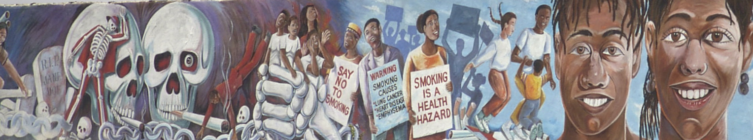 Decorative mural that shows skulls and cigarettes on the left side. In the middle are some young black people caught in the first of the smoking skulls. Three black adults hold signs that read "Say no to smoking," "Warning: Smoking causes lung cancer, heart disease, emphysema," and "Smoking is a health hazard." Next are a black family playing together, and then the close up of two Black people.