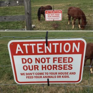 Sign attached to fence states "Attention Do Not Feed Our Horses We Don't Come to Your House and Feed Your Animals or Kids